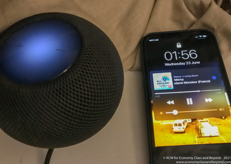 a smart phone next to a black speaker