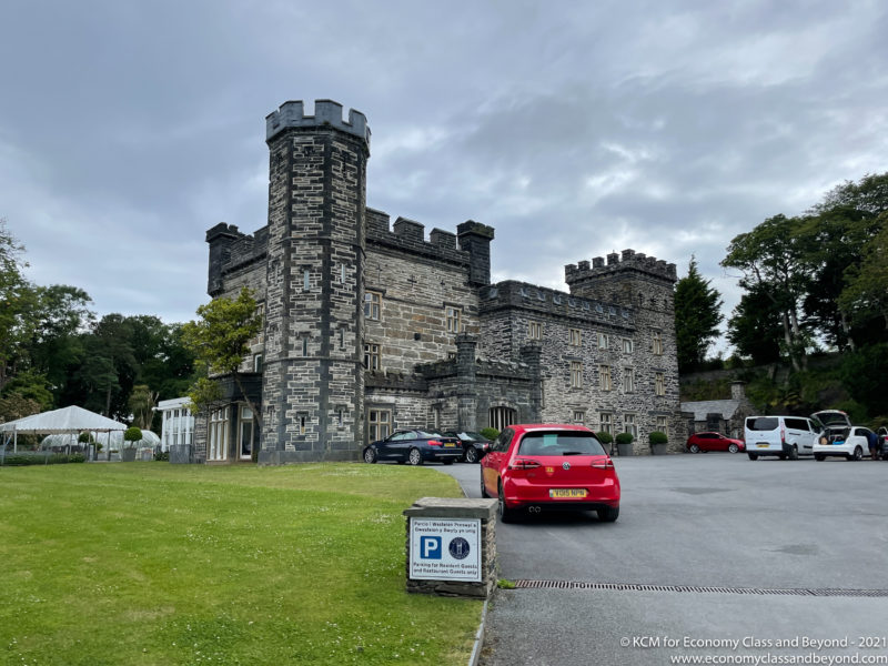 a car parked in front of a stone castle