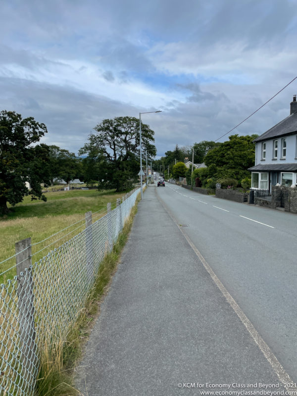 a road with a fence and houses