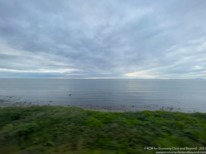 a view of the ocean from a window of a car