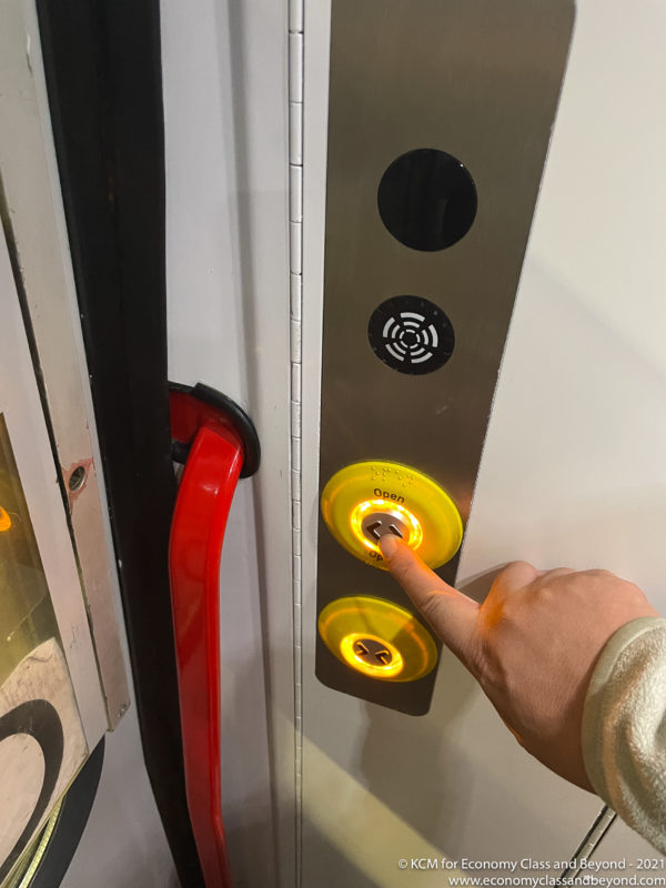 a hand pressing a button on a elevator