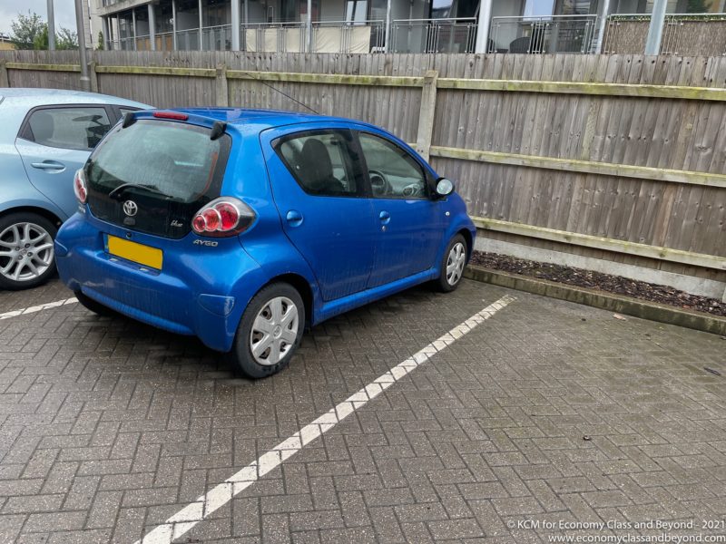 a blue car parked in a parking lot