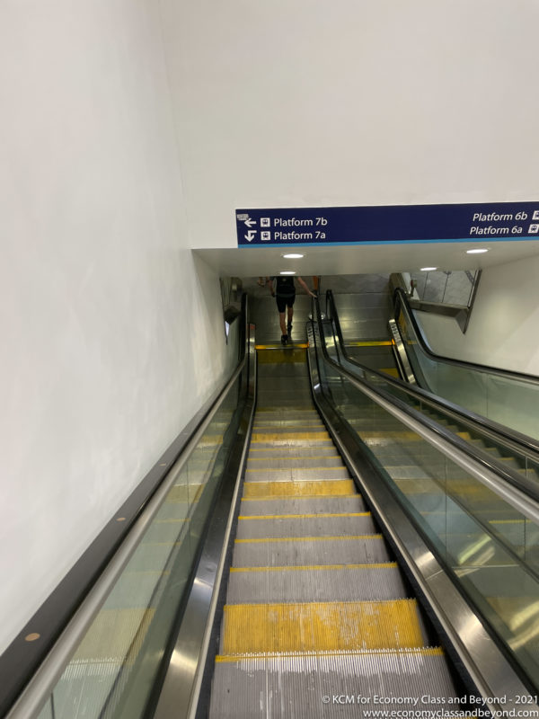 a person walking on an escalator