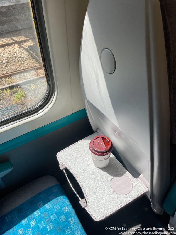 a cup on a table in a train