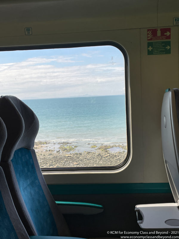 a view of the ocean from a window of a train