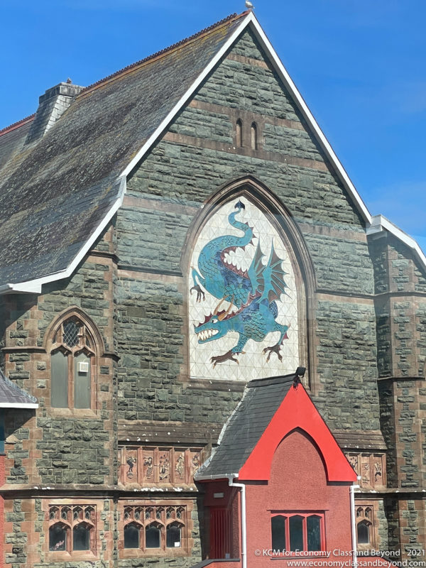 a stone building with a dragon on the side