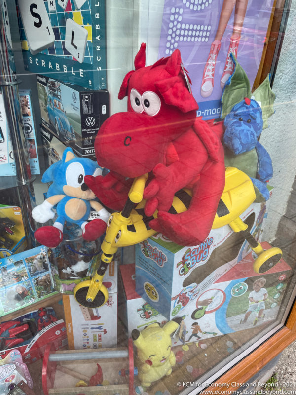 a red dragon on a scooter in a store window