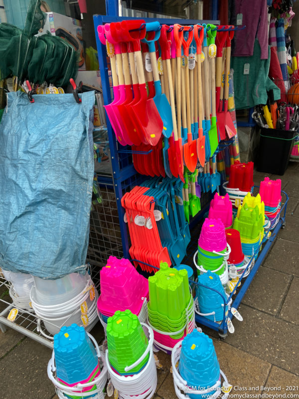 a display of colorful shovels and buckets