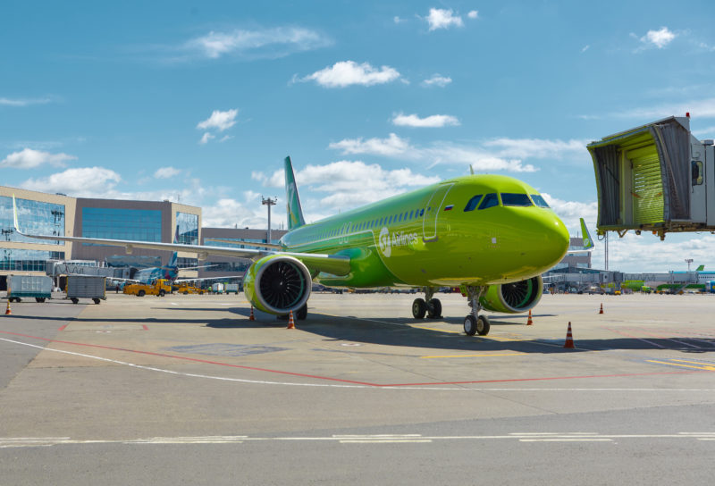 a green airplane on a tarmac