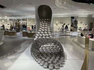 a large sculpture of pots on a display in a mall