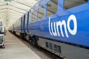 a blue train in a station