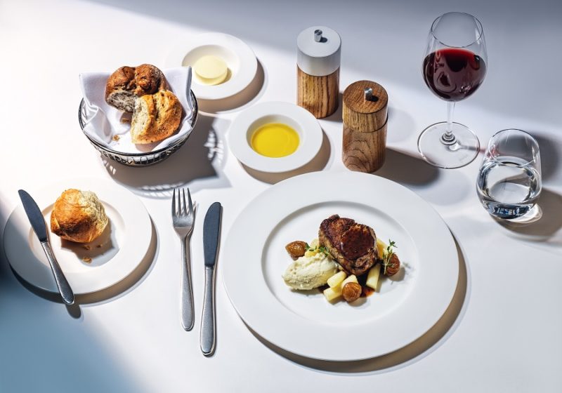a table with plates of food and wine