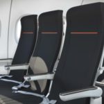 a row of black seats in a plane