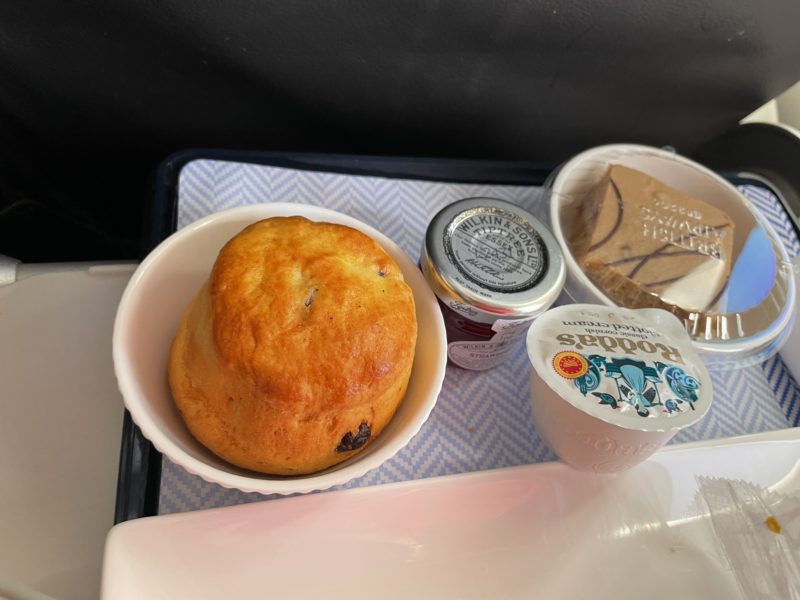 a tray with food and a cup of yogurt