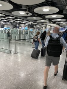 a group of people walking with luggage in an airport