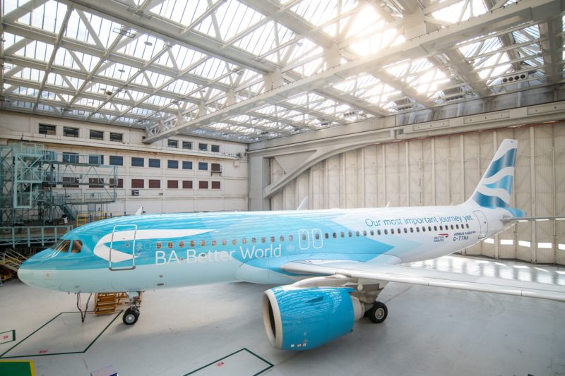 a blue airplane in a hangar