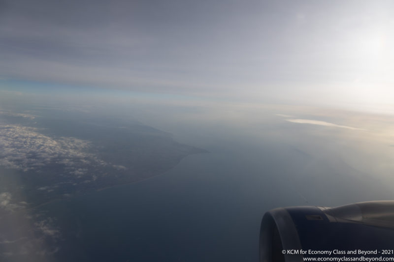 an airplane wing and the ocean