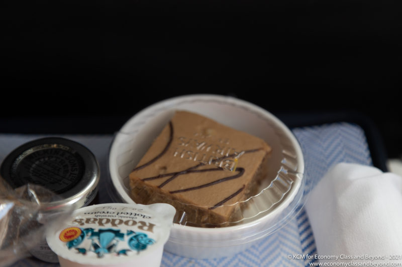 a brown cake in a plastic container