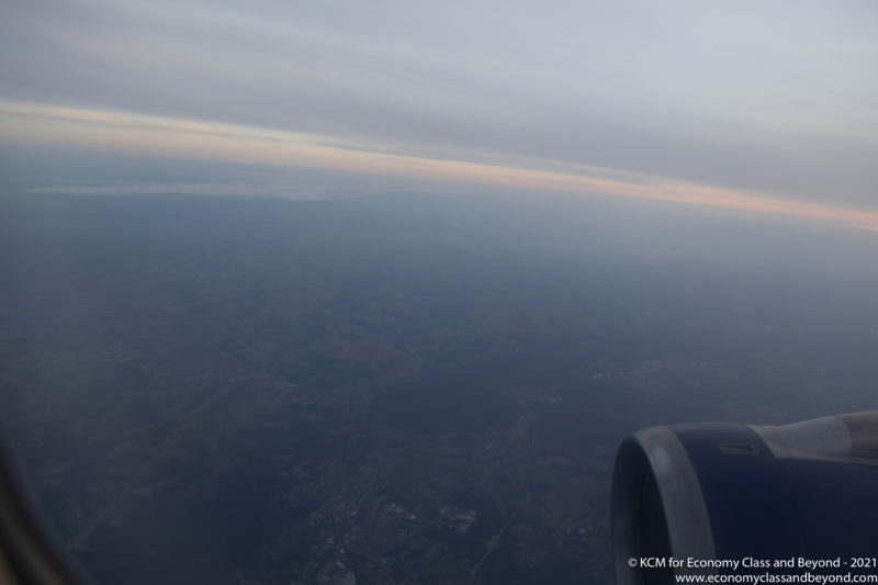 an airplane wing and a view of the earth from the window