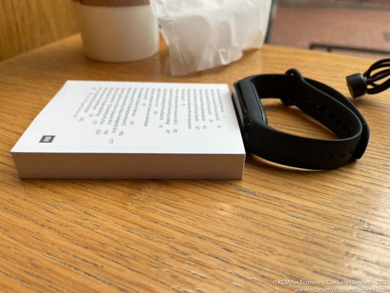 a book and a smart watch on a table