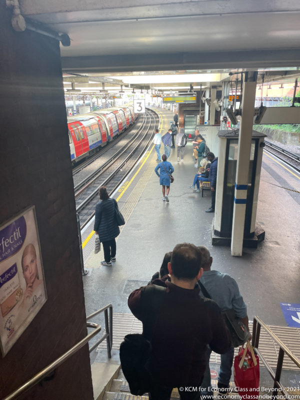 people standing on the platform of a train station