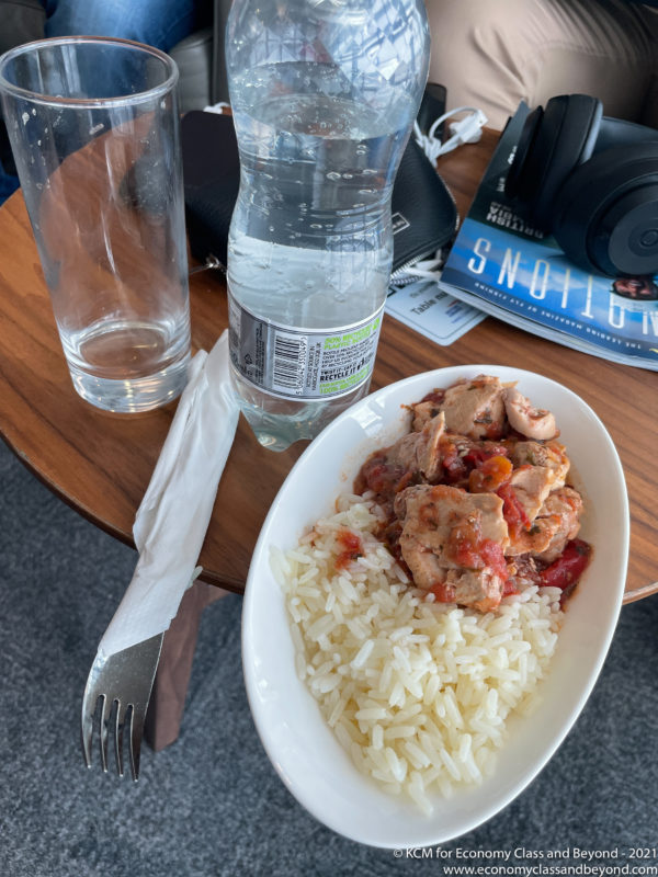a plate of rice and chicken on a table