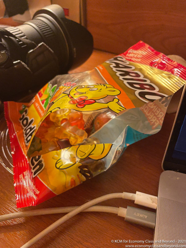 a bag of candy next to a camera