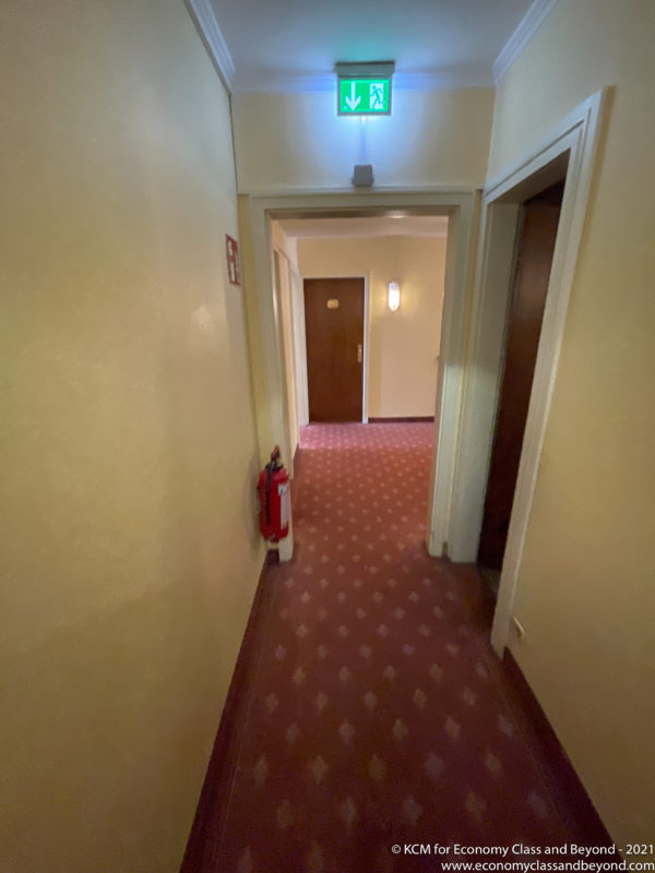 a hallway with a fire extinguisher