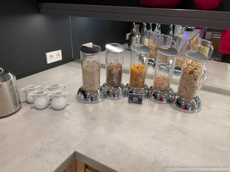 a group of cereals in containers on a counter