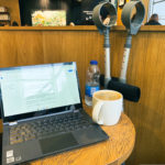 a laptop and a cup of coffee on a table