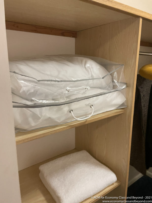 a white pillow in a clear bag on a shelf