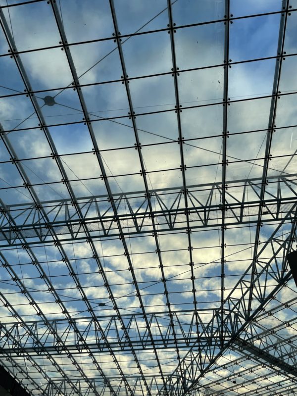 a glass roof with sky and clouds