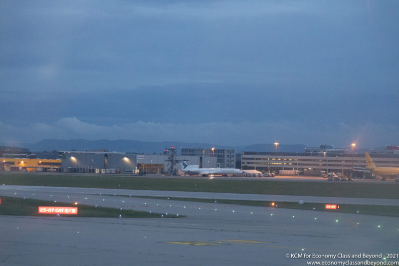 an airport runway with lights and buildings