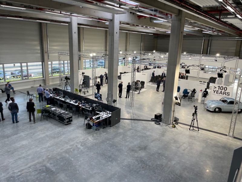 a large room with many equipment and people standing around