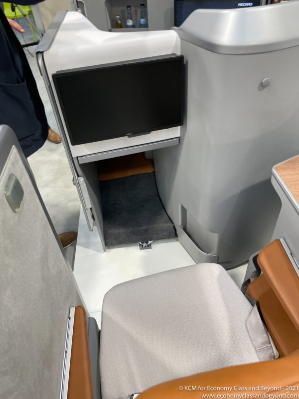 a small computer screen in an airplane