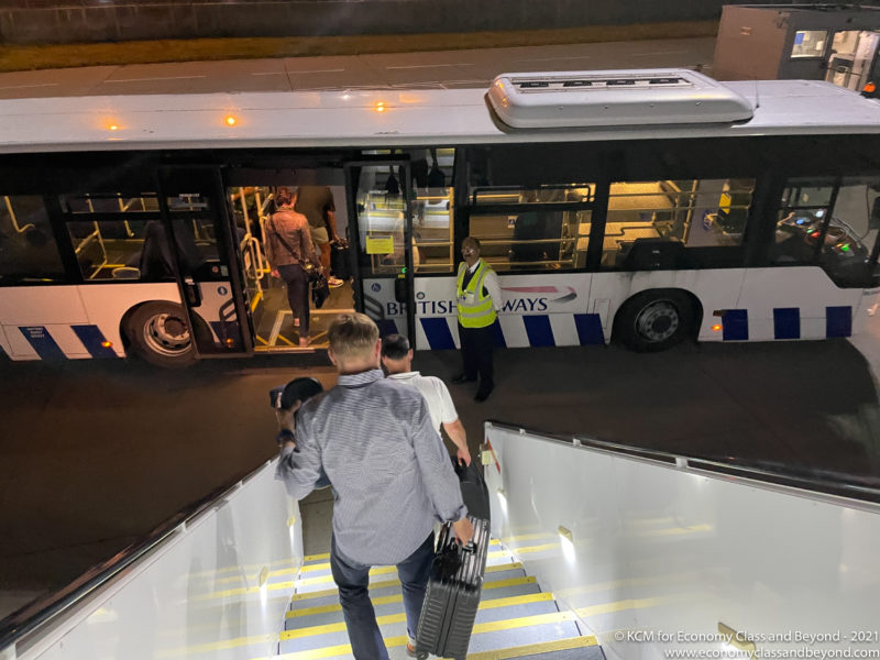 a group of people walking up stairs to a bus