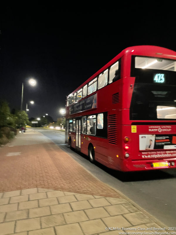 a red double decker bus on a street