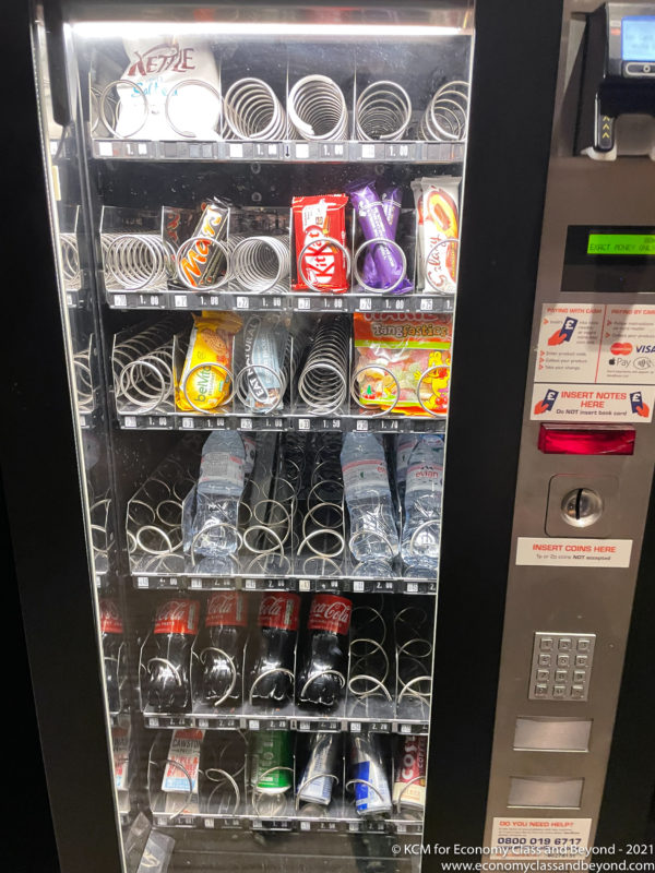 a vending machine with soda and snacks