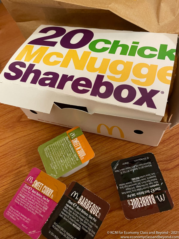 a fast food box and small packages on a table