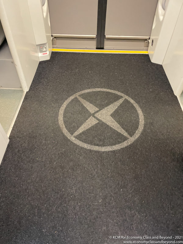 a grey carpet with a white x on it