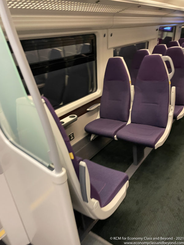 a row of purple seats in a train