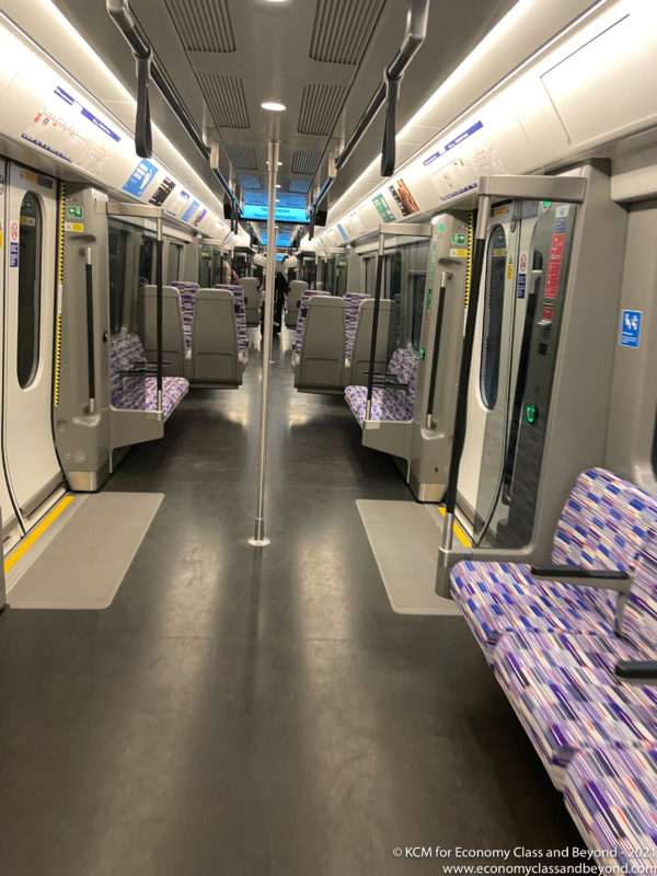 a train with seats and a pole