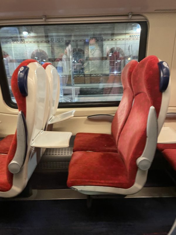 a red and white seats on a train