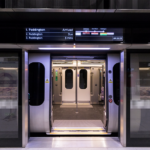 a train with a sign and doors