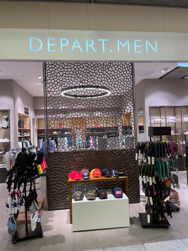 a store with a sign and a display of clothes