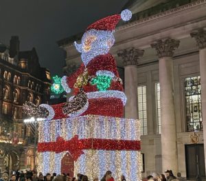 a large statue of santa claus with lights on it