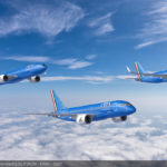 a group of blue airplanes in the sky