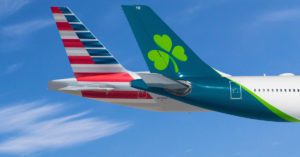 the tail of an airplane with a clover on the tail