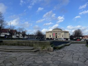 a stone square with a building in the background