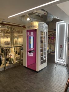 a pink and white telephone booth